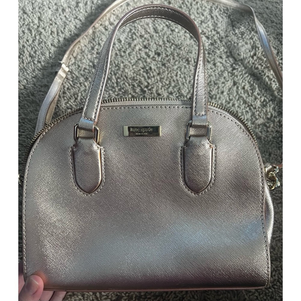A beautiful shiny rose gold Kate spade purse